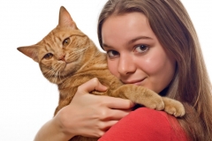 Teen holding her pet cat