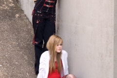 Two teen models by contrete wall