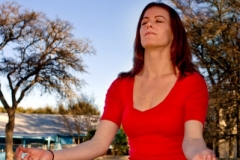 Attractive woman meditating outdoors