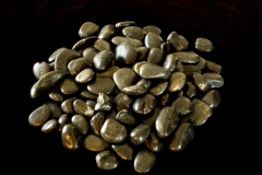 River rocks against black