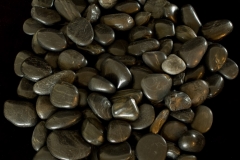 River rocks against black